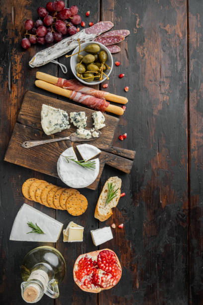 istock Spanish snacks, meat cheese, herbs, on dark wooden background, flat lay  with copy space for text 1294404808