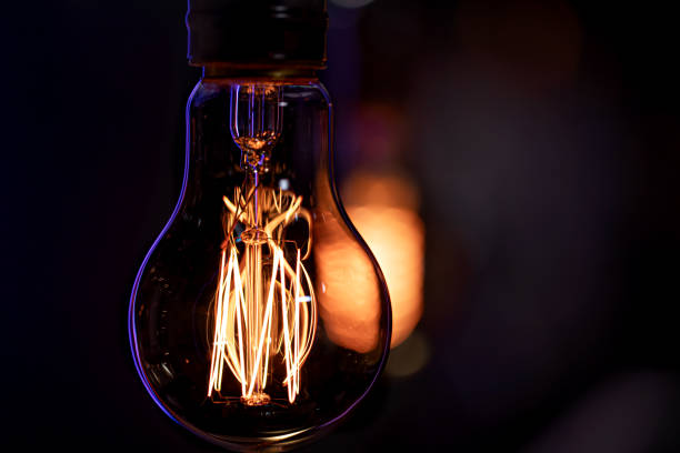 istock Close up of a burning lamp on a blurred dark background. 1294404897