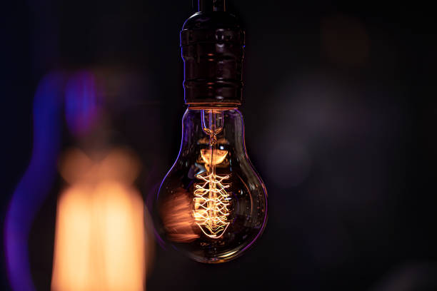 istock Close up of a burning lamp on a blurred dark background. 1294404898