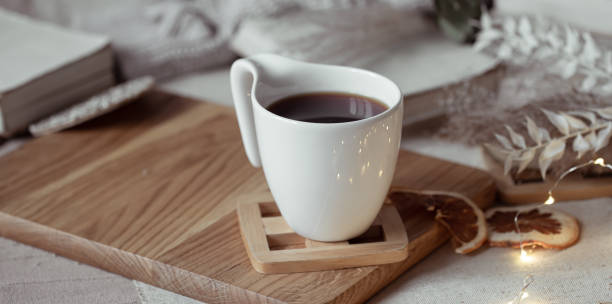 istock Close up of a white cup with a hot drink on a blurred background. 1294405758