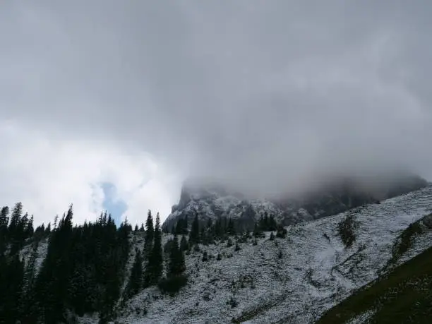 The 1986 meter high mountain Aggenstein in the bavarian alps near the german town Pfronten with clouds and snow