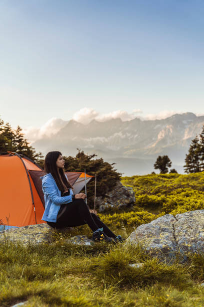istock Beautiful woman relaxing on camping trip 1294406045