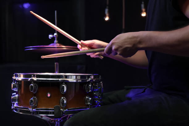 istock Drummer playing snare drum with sticks close up. 1294406114