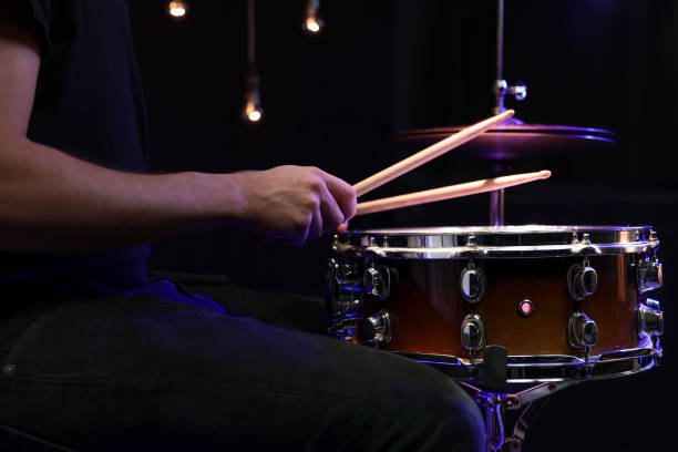 istock Drummer playing snare drum with sticks close up. 1294406119