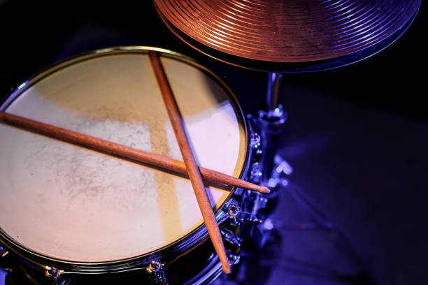 istock Drum sticks on a snare drum close up top view. 1294406134