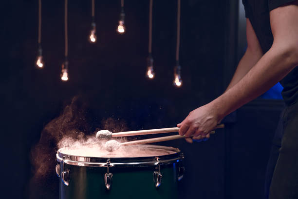 istock The drummer plays with mallets on floor tom in dark room. 1294406137