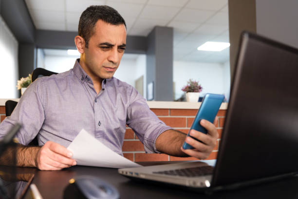 istock Tired Man In Office Has Difficulty To See Texts On His Smartphone, Concept For The Beginning Of Presbyopia Just After The Age Of 40 Years. 1294408304