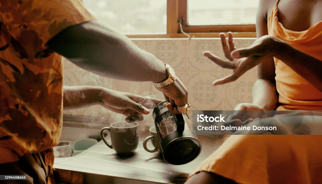 The best mornings are made with a good brew Shot of an unrecognisable couple having coffee together in the kitchen at home Coffee - Drink Stock Photo
