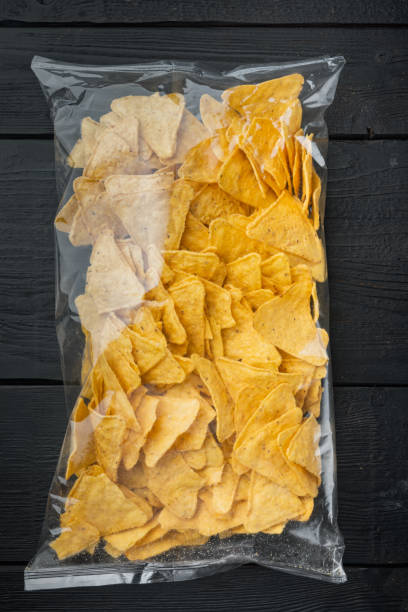 istock Package corn traditional nachos, on black wooden background, top view or flat lay 1294408944