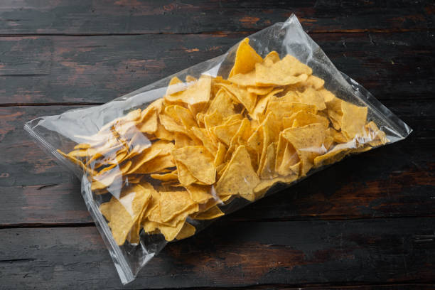 istock Nachos corn tortilla in bag, on old wooden table 1294409479