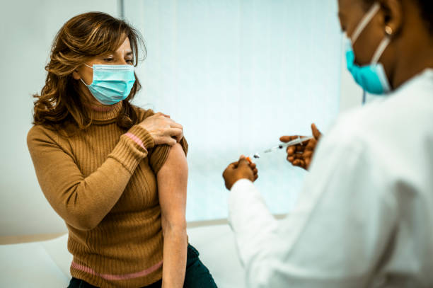 istock Middle aged woman getting vaccinated 1294409591