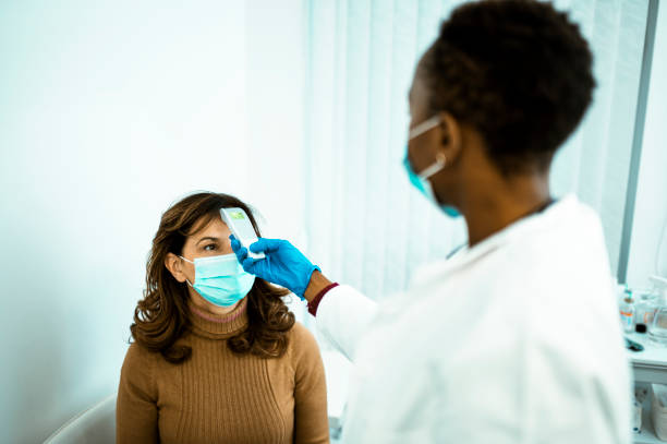 istock Middle aged woman at doctors office 1294409598