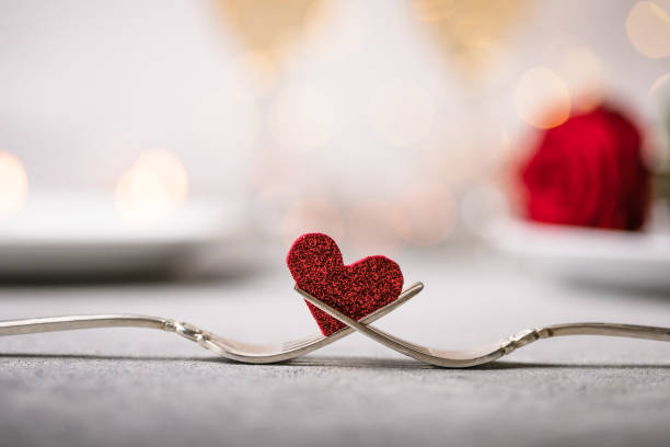 Forks and a heart. Holiday menu for Valentines Day. stock photo