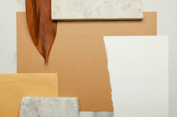 istock Marble stones, brown and white paper, dried exotic leaf on the desk.Empty space for design 1294409877