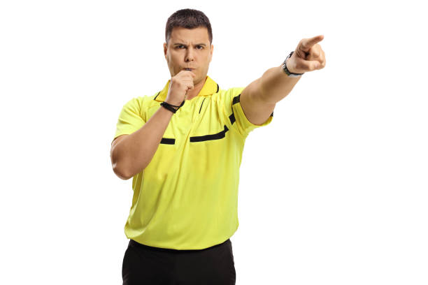 istock Sports referee blowing a whistle and pointing with finger 1294411281