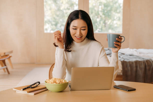 Young teenage Asian woman wears sweater with pretty smile in bed room. Happy smiling girl using laptop with notebook watching movies, films, videos online. 
Online technology concept. Young teenage Asian woman wears sweater with pretty smile in bed room. Happy smiling girl using laptop with notebook watching movies, films, videos online. 
Online technology concept popcorn snack bowl isolated stock pictures, royalty-free photos & images