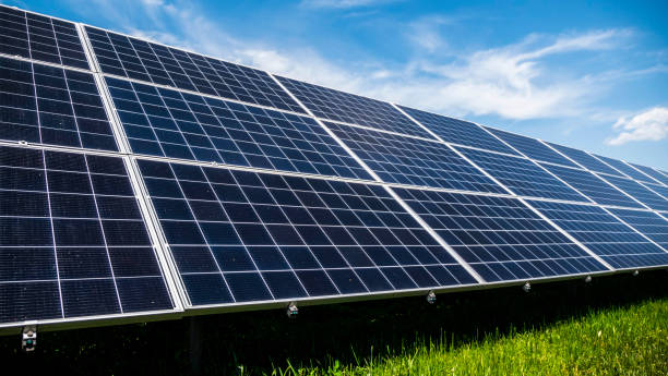 istock Solar power plant panels on a green meadow against a blue sky with clouds 1294412408