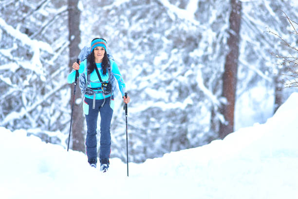 istock Young woman practicing ski touring during a snowfall in the woods 1294412509