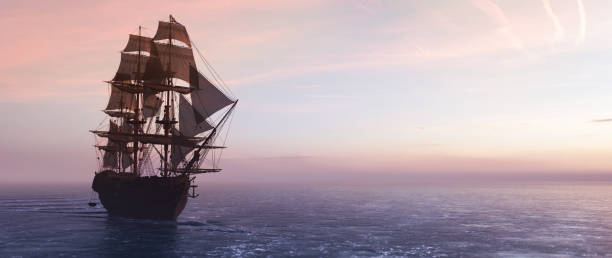 istock Pirate ship sailing on the ocean at sunset 1294412698