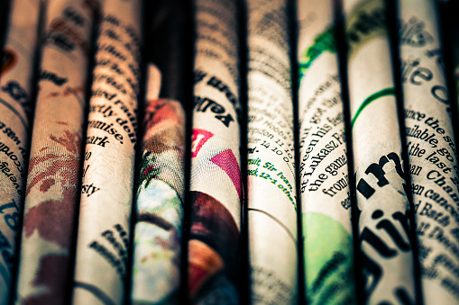 Macro abstract image depicting rolled sheets of newspaper.