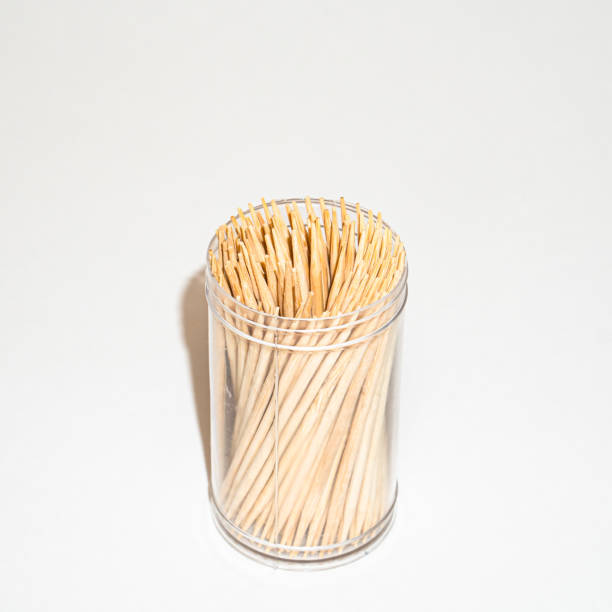 istock Wooden toothpicks in a plastic jar isolated on white background 1294416900
