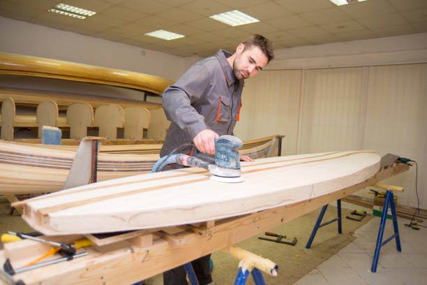 istock Young carpenter making wooden canoe 1294419464