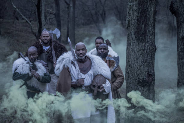 A tribe of Five African Viking inspired Warriors in a smoke filled forest battle scene