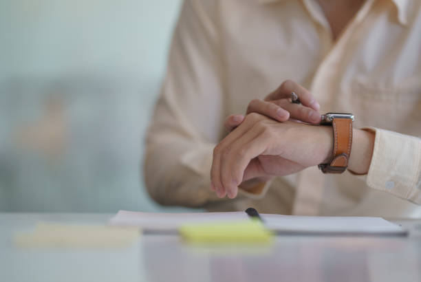 istock Businessman looking at his watch in his hand. 1294419612