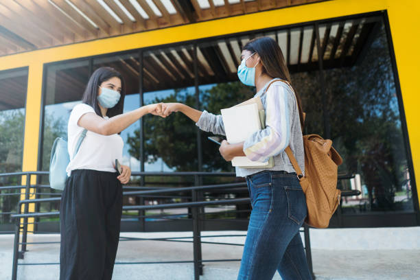 istock College friends returning to campus wearing protective face masks 1294421729