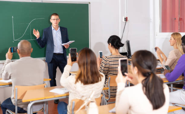 istock Teacher explaining new theme to adult students 1294422665