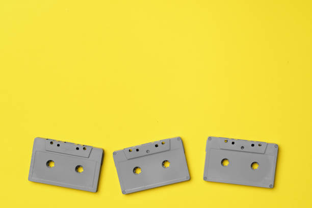 istock Gray audio cassette on yellow background top view 1294423653