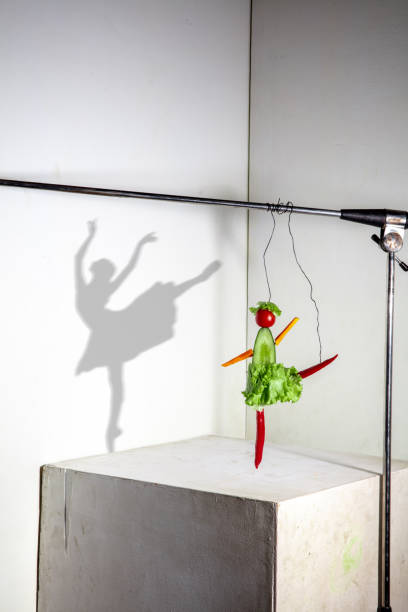 istock Flying food composition making beautiful ballerina drawing shadow on the wall 1294423876