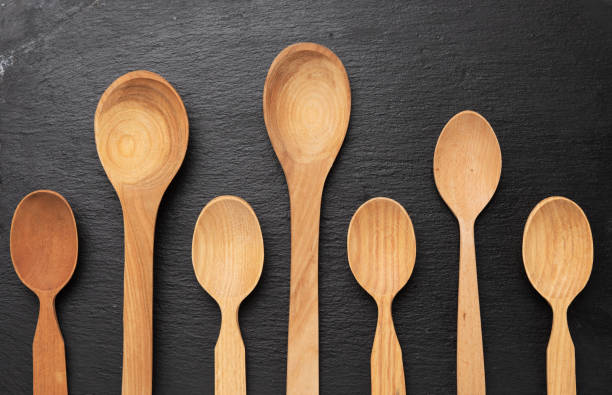 istock empty wooden spoons on a a black background, top view 1294426506