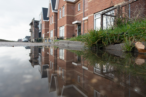 quiet street 10 new houses along canal puddle on surface level during lockdown