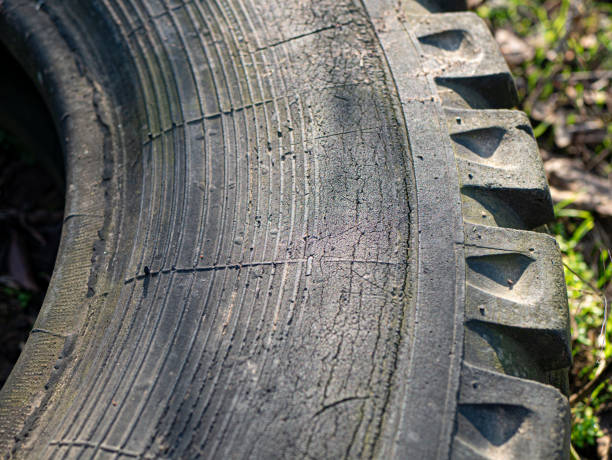 istock Old dirty tire on grass background 1294429092