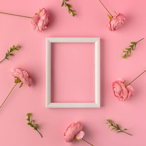 istock Feminine pink layout with white frame with space for text and rose blooms 1294429501