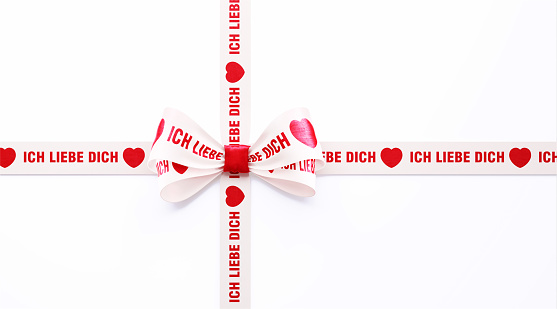 I Love You - Ich Liebe Dich written in German red and white ribbon over white background. Horizontal composition with clipping path and copy space. Valentine's Day concept.