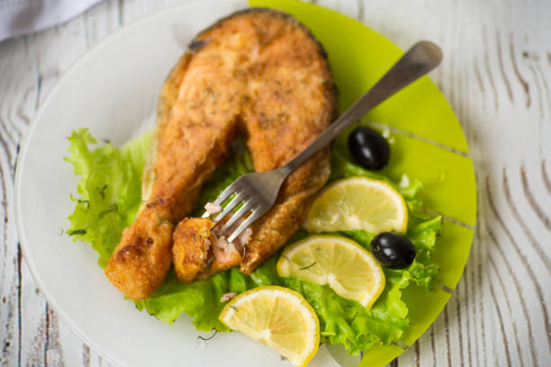 istock piece of fried salmon fish in a plate with lemon 1294432637