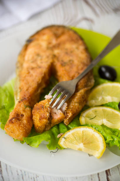 istock piece of fried salmon fish in a plate with lemon 1294432658