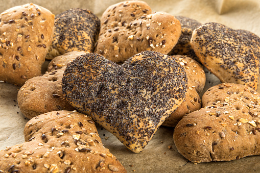 Buns in heart shape with poppy seeds and grains