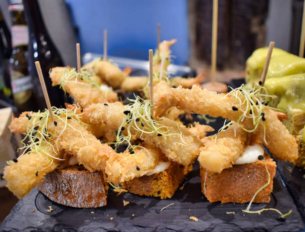 istock Prawn skewers and lids with crispy batter over bread tacos 1294435883