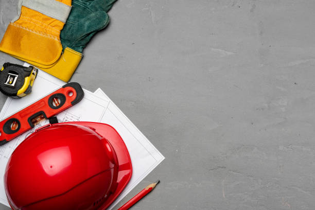 istock Hardhat, gloves and blueprints of a builder 1294436505