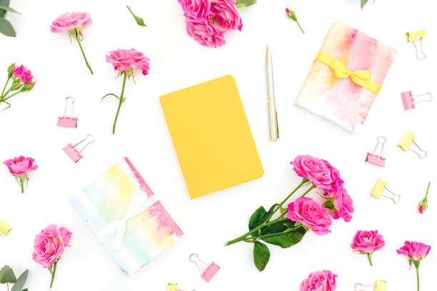 istock Composition with notebook, pen, gifts and roses flowers on white background. Flat lay. Top view 1294437398