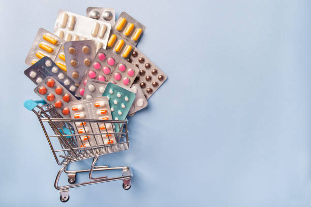 cart from pharmacy with medicines and pills on blue background with copy space. - note pad medicine healthcare and medicine pharmacy imagens e fotografias de stock