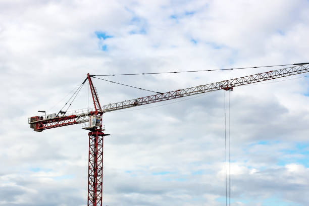 istock High crane for house building at construction site on blue sky background 1294438713
