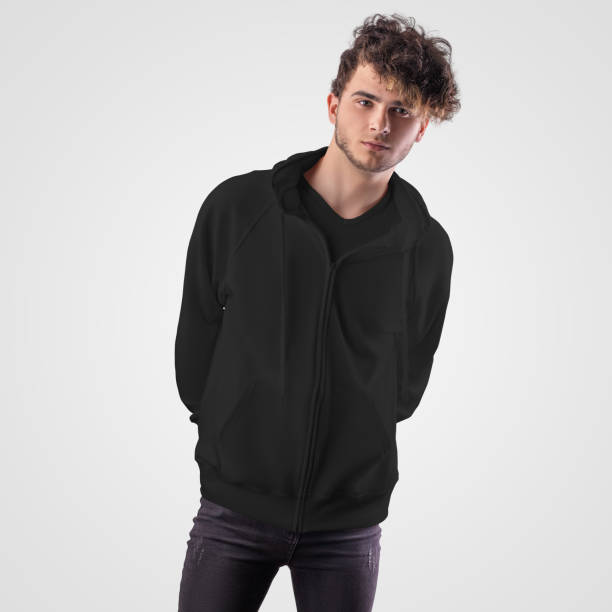 istock Black hoodie mockup with pocket, zipper closure, drawstrings on the hood, dressed on a guy, front view, isolated on background. 1294440451