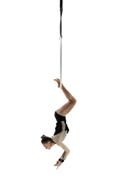 istock Young female acrobat, circus athlete isolated on white studio background. Training perfect balanced in flight 1294441630