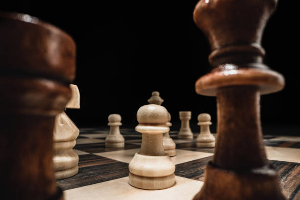 istock Chess game with chess pieces against black background 1294441758