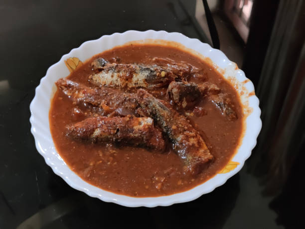 istock delicious Kerala style fish curry in a bowl isolated on black background 1294442471