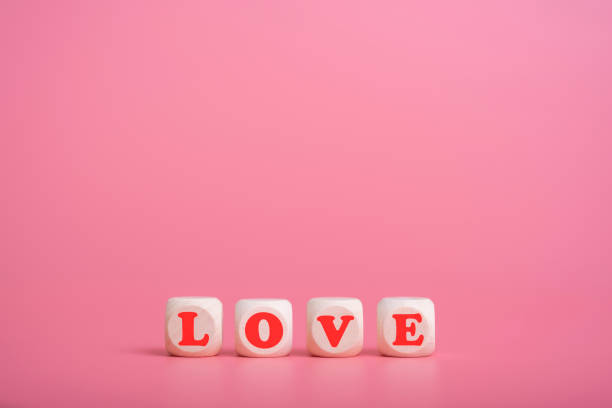 istock Text wooden blocks spelling the word love on pink background 1294442896